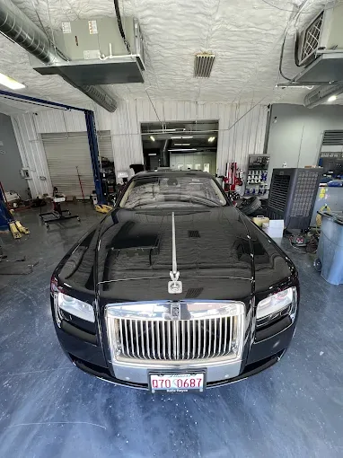 Rolls-Royce Spectre in the service bay — loaner and rental coordination at Westway Collision Center in Carrollton, TX